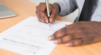 A man reviewing appraisal paperwork with pen in hand