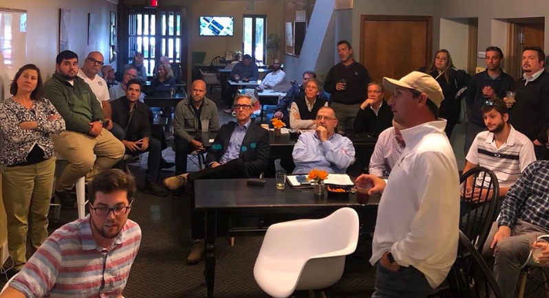 Large Semi Truck driving on the highway with the sun setting in the distance